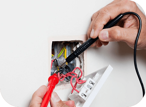 A person is holding a pair of scissors and wires.